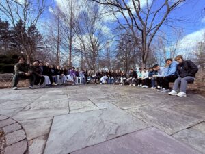Students sitting on half circle bench.